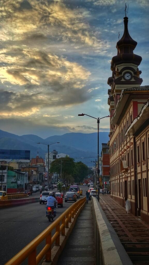 Beautiful sunset over Ibagué, Colombia, featuring iconic clock tower and street view.